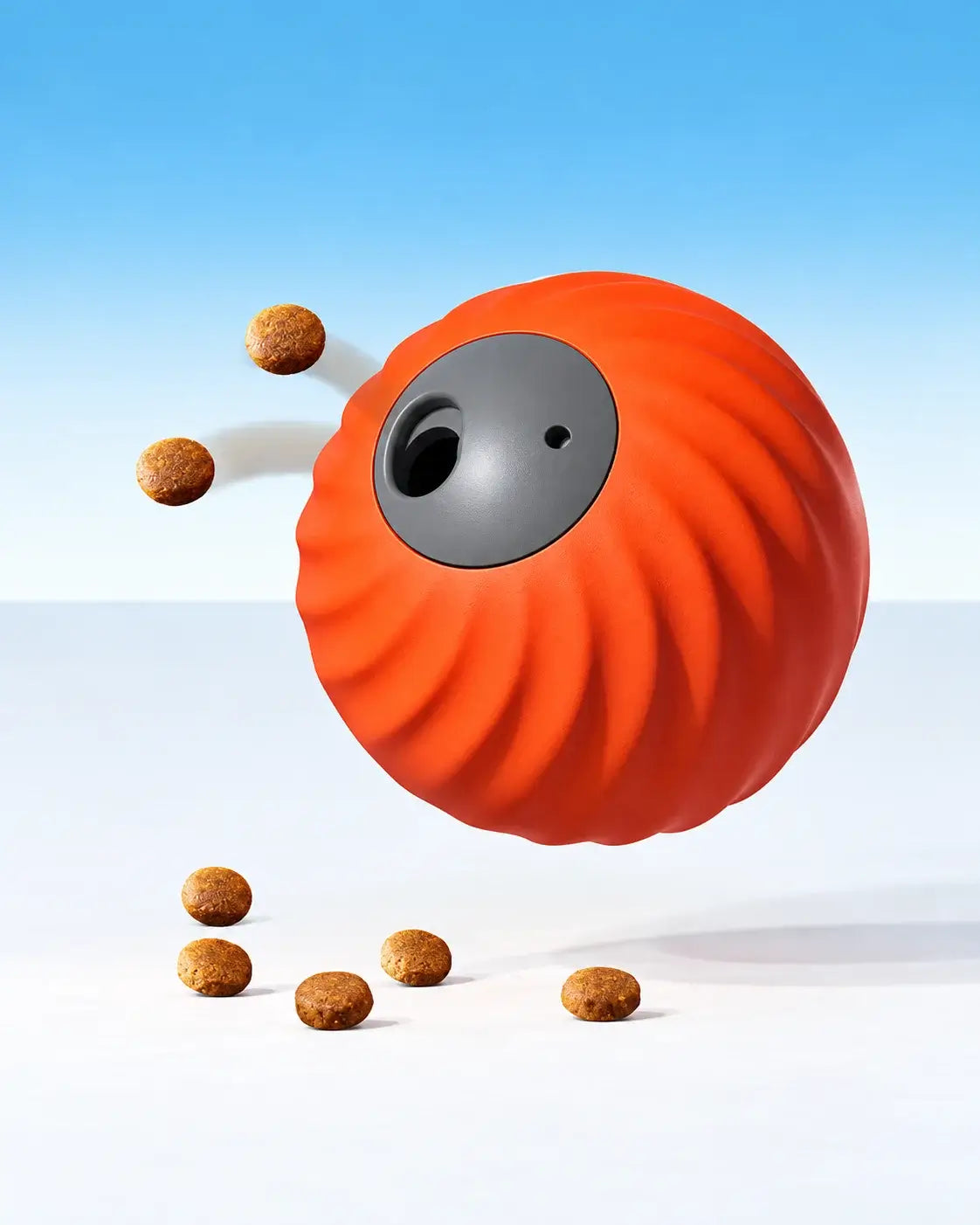 Orange automatic treat-dispensing dog ball releasing kibble through its food opening