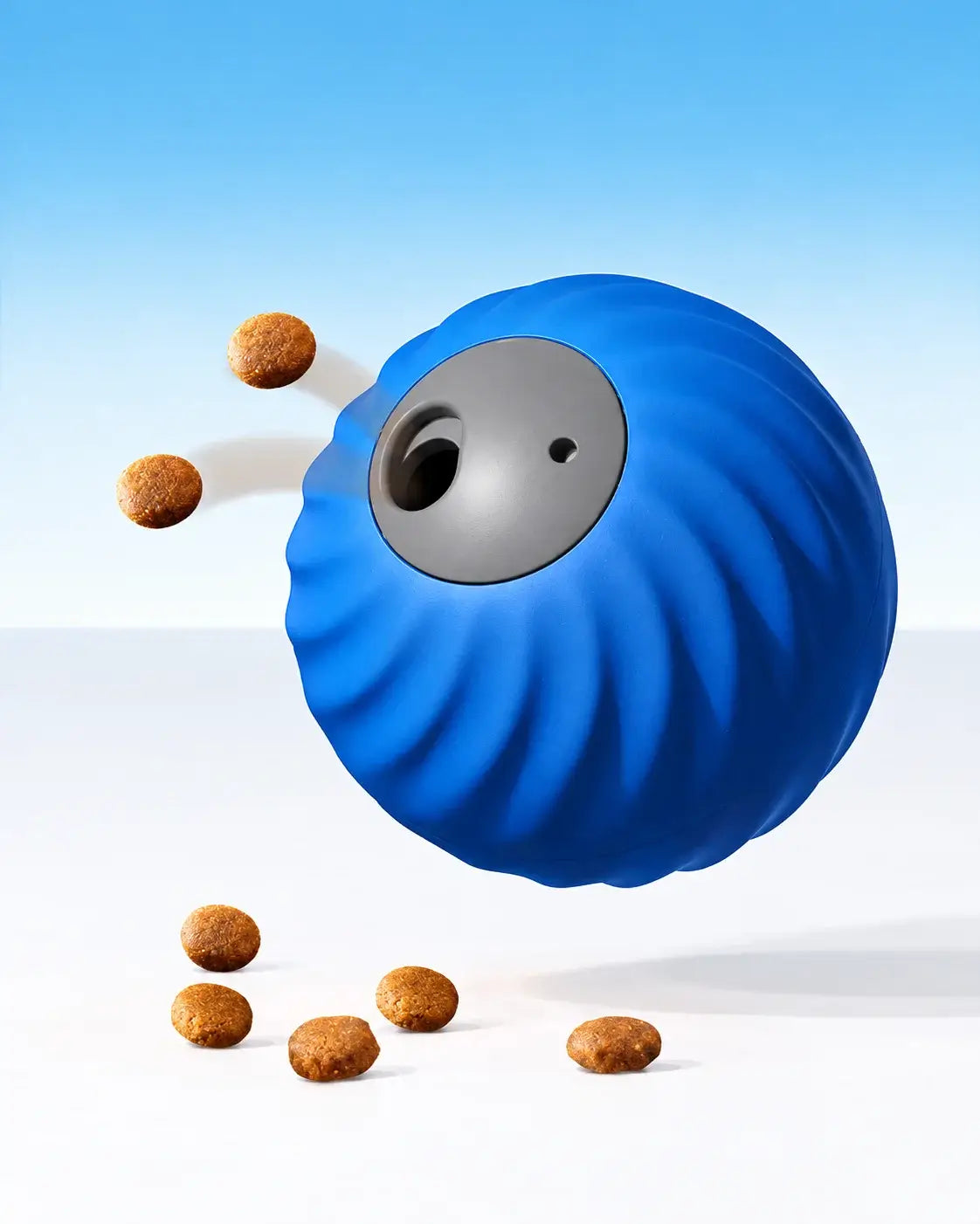 Blue automatic treat-dispensing dog ball releasing kibble through its food opening